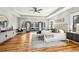 Relaxing main bedroom featuring a seating area, hardwood floors, a ceiling fan, and two dressers at 812 Stratford Rd, Avondale Estates, GA 30002