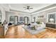 Spacious main bedroom featuring hardwood floors, tray ceilings, a ceiling fan, and access to a private outdoor seating area at 812 Stratford Rd, Avondale Estates, GA 30002