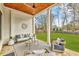 Covered outdoor patio with comfortable seating, a ceiling fan, and views of the lush backyard at 812 Stratford Rd, Avondale Estates, GA 30002