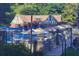 Community pool area with ample seating, umbrellas, and a charming pool house in a beautiful setting at 812 Stratford Rd, Avondale Estates, GA 30002