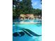 Large community pool with a view of the pool house, surrounded by lounge chairs and manicured landscaping at 812 Stratford Rd, Avondale Estates, GA 30002