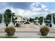 Picturesque town square with decorative pillars, colorful umbrellas, and landscaped flower pots at 812 Stratford Rd, Avondale Estates, GA 30002