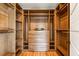 Custom walk-in closet with wood shelves, drawers, wood floors, and ample storage space at 812 Stratford Rd, Avondale Estates, GA 30002