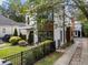 Modern two-story home with wood and white siding, landscaped lawn, and black fence at 139A Walthall Se St, Atlanta, GA 30316