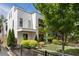 Contemporary home with white siding and wood accents, landscaped yard, and black fence at 139A Walthall Se St, Atlanta, GA 30316