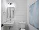 Modern powder room with white shiplap walls and floating vanity at 139A Walthall Se St, Atlanta, GA 30316