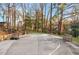 Private basketball court with benches and mature trees provides an outdoor sports and relaxation space at 3456 Paces Nw Pl, Atlanta, GA 30327