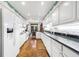 Open kitchen featuring white cabinets, subway tile backsplash, granite counters, view to dining area at 3456 Paces Nw Pl, Atlanta, GA 30327
