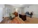 Home office with hardwood floors, built-in shelving, and window shutters at 3456 Paces Nw Pl, Atlanta, GA 30327