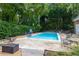 Inviting in-ground pool surrounded by lush landscaping, multiple seating areas, and a half-court basketball at 3456 Paces Nw Pl, Atlanta, GA 30327