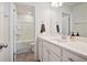Well-lit bathroom featuring a white vanity, framed mirror, and a separate shower at 79 Dew Drop Ln, Dallas, GA 30157
