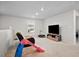 Spacious bonus room with a TV, comfortable seating, and a play area for  at 79 Dew Drop Ln, Dallas, GA 30157