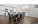 Dining area with seating for six, modern lighting, and a view of the backyard at 79 Dew Drop Ln, Dallas, GA 30157