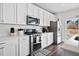 Well-equipped kitchen with stainless steel appliances, white cabinets, and granite countertops at 79 Dew Drop Ln, Dallas, GA 30157