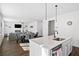 Open-concept kitchen and living area with hardwood floors, modern island and stylish appliances at 79 Dew Drop Ln, Dallas, GA 30157