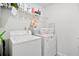 Functional laundry room with a washer, dryer, wire shelving for storage, and overhead lighting at 79 Dew Drop Ln, Dallas, GA 30157