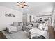 Spacious living room with a comfortable sectional couch, ceiling fan, and decor at 79 Dew Drop Ln, Dallas, GA 30157