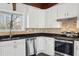 Modern kitchen with white cabinets and granite countertops at 4079 Navajo Ne Trl, Brookhaven, GA 30319