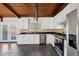 Modern kitchen with white cabinets, granite counters, and stainless steel appliances at 4079 Navajo Ne Trl, Brookhaven, GA 30319