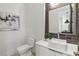 Modern powder room with white vanity, dark tile, and contemporary fixtures at 910 Ponce De Leon Ne Ne Ave # 3, Atlanta, GA 30306