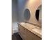 Bathroom featuring a double sink vanity with stone countertops, dual round mirrors, and a soaking tub at 1799 Timber Valley Se Way, Smyrna, GA 30080