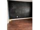 Bedroom featuring a black chalkboard wall and rich wood flooring, offering a unique and stylish touch at 1799 Timber Valley Se Way, Smyrna, GA 30080
