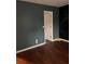 Bedroom featuring dark green and black chalkboard accent walls and rich laminate wood flooring at 1799 Timber Valley Se Way, Smyrna, GA 30080