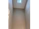 Hallway leading to a sky light with neutral walls, white trim, and minimal natural light at 1799 Timber Valley Se Way, Smyrna, GA 30080