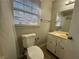 Bathroom with vanity, toilet, and window with blinds at 4208 Rue Saint Michel, Stone Mountain, GA 30083