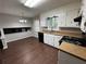Eat-in kitchen with white cabinets, dark countertops, and new flooring at 4208 Rue Saint Michel, Stone Mountain, GA 30083