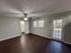 Bright living room with hardwood floors, ceiling fan, and access to backyard at 4208 Rue Saint Michel, Stone Mountain, GA 30083
