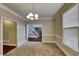 Bright dining room with neutral walls and carpeting at 10845 Grenadier Ln, Alpharetta, GA 30022