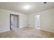 Spacious bedroom showing access to bathroom and closet with neutral carpet flooring at 2159 Meadow Peak Rd, Duluth, GA 30097