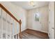 Welcoming entryway with wood-look floors, a front door with glass panes, and staircase at 2159 Meadow Peak Rd, Duluth, GA 30097