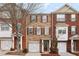 Charming brick townhome featuring a well-manicured lawn and an attached one car garage at 2159 Meadow Peak Rd, Duluth, GA 30097