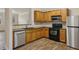Kitchen with stainless steel appliances, granite countertops, and wood cabinets at 2159 Meadow Peak Rd, Duluth, GA 30097