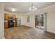 Open-concept kitchen with stainless steel appliances, and wood-look vinyl flooring at 2159 Meadow Peak Rd, Duluth, GA 30097