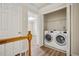 Upstairs laundry room with modern front-loading washer and dryer at 2159 Meadow Peak Rd, Duluth, GA 30097