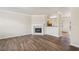 Open-concept living area with a fireplace and elegant hardwood flooring at 2159 Meadow Peak Rd, Duluth, GA 30097