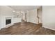 Spacious open-plan living area featuring hardwood flooring, a fireplace and neutral paint at 2159 Meadow Peak Rd, Duluth, GA 30097