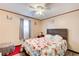 Bedroom with floral bedding, ceiling fan, and wood-look flooring at 2515 Impala Dr, Cumming, GA 30041