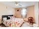 Spacious bedroom with floral bedding, ceiling fan, and a wooden chair at 2515 Impala Dr, Cumming, GA 30041