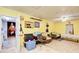 Additional room with yellow walls, wicker furniture, and access to the kitchen at 2515 Impala Dr, Cumming, GA 30041