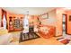 Bright dining room features wood floors, a table with chairs, and an orange color scheme at 2515 Impala Dr, Cumming, GA 30041
