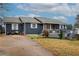 Ranch style home with gray siding, deck, and spacious yard at 2515 Impala Dr, Cumming, GA 30041