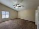 Spacious bedroom with ceiling fan and large window at 5391 Walker Rd, Stone Mountain, GA 30088