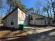 Two-story house with stone and wood siding, a two-car garage, and a long driveway at 5391 Walker Rd, Stone Mountain, GA 30088
