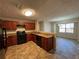 Galley kitchen with granite countertops and dark wood cabinets at 5391 Walker Rd, Stone Mountain, GA 30088