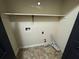 Laundry closet with shelving and hookups at 5391 Walker Rd, Stone Mountain, GA 30088