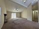 Large living room featuring vaulted ceilings, a fireplace, and access to the patio at 5391 Walker Rd, Stone Mountain, GA 30088